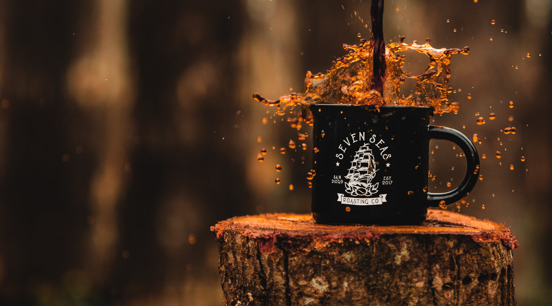 Close up shot of a coffee mug with coffee splashing out of it.
