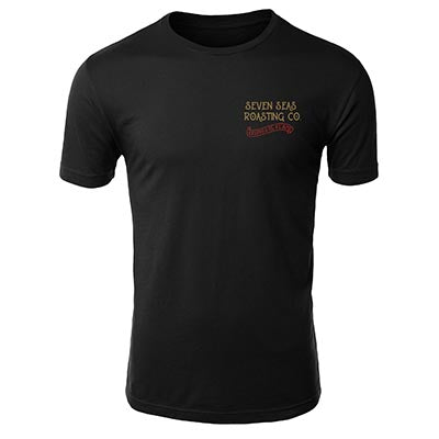 Front of Black t-shirt with keeper of the flame art work in red and gold and seven seas roasting written on top left
